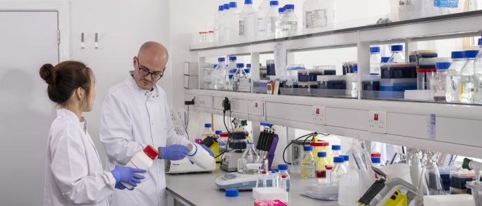 Two researchers working in a lab in the British Heart Foundation Centre of Research Excellence for Heart Failure Prevention and Treatment