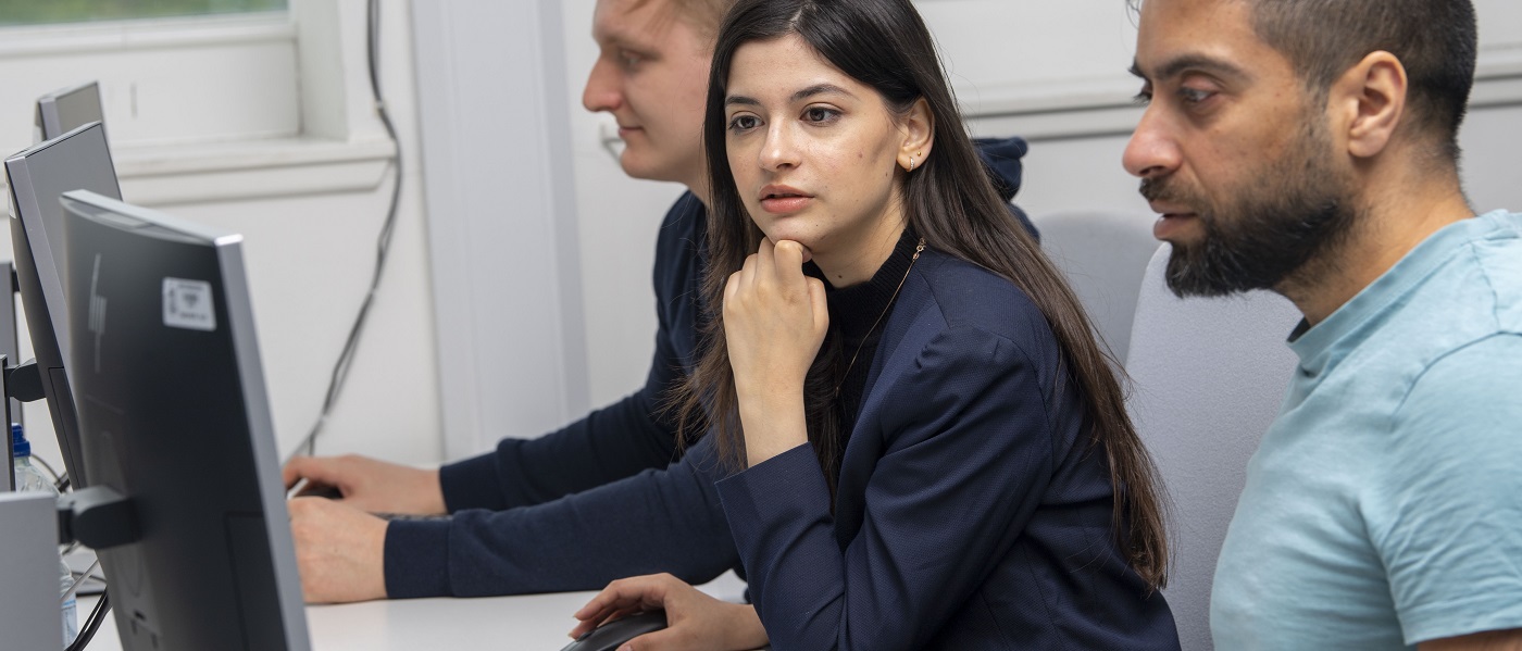 Three computing science students using computers