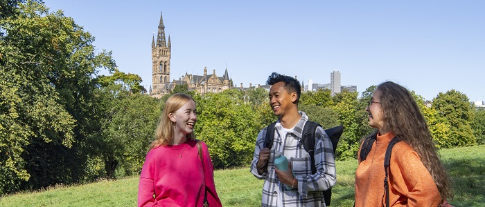 Photo of students in Kelvingrove Park on a sunny day with the tower in the background