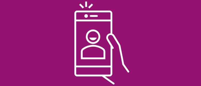 White icon on pink background depicting a hand holding a smartphone