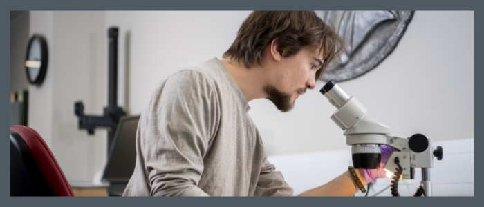 For decorative puposes only - male looking into a microscope