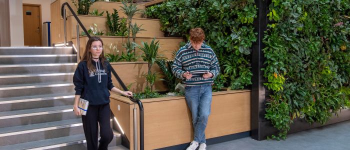 Student walking down the stairs in the Clarice Pears building