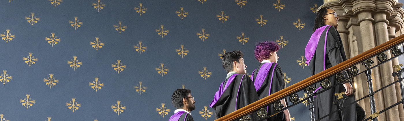 Students standing on the stairs during graduation at the University of Glasgow
