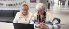 An image of two women looking at a laptop