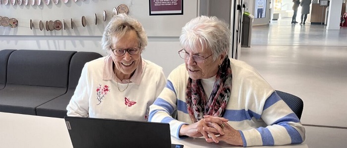 An image of two women looking at a laptop