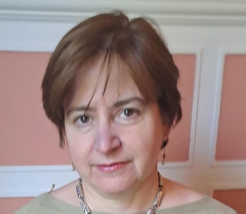 Claire McDiarmid standing with a pink background Source: School of Law