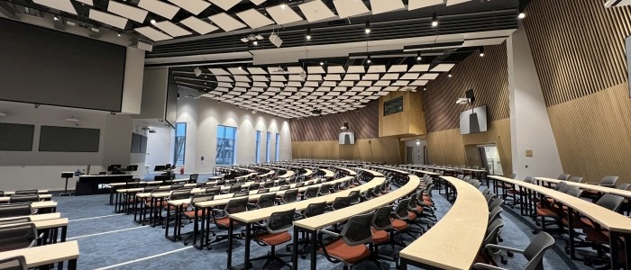 View of a lecture theatre, showing the seating and primary teaching wall.