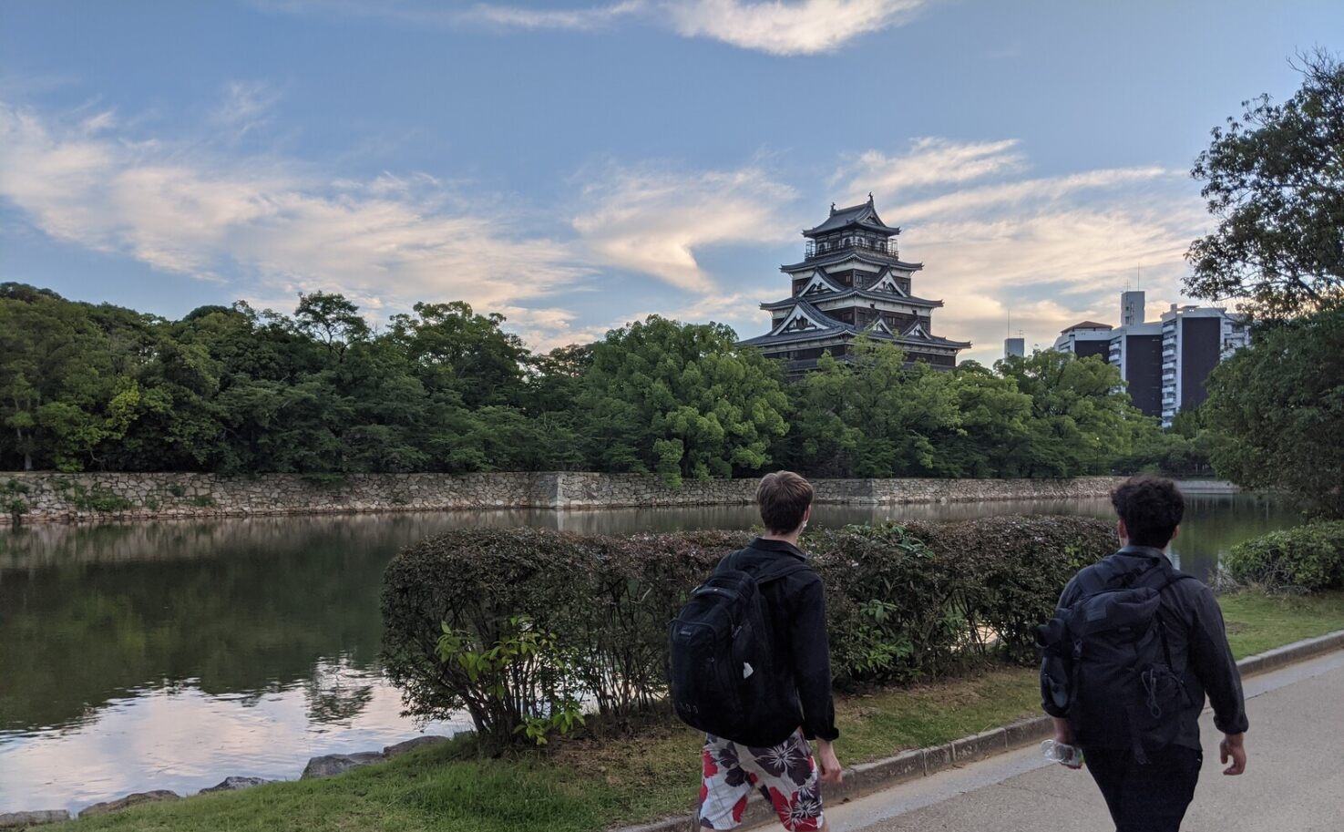 Two students walking next to a river in Kyoto