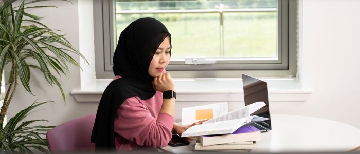 Student studying at Dumfries Campus library