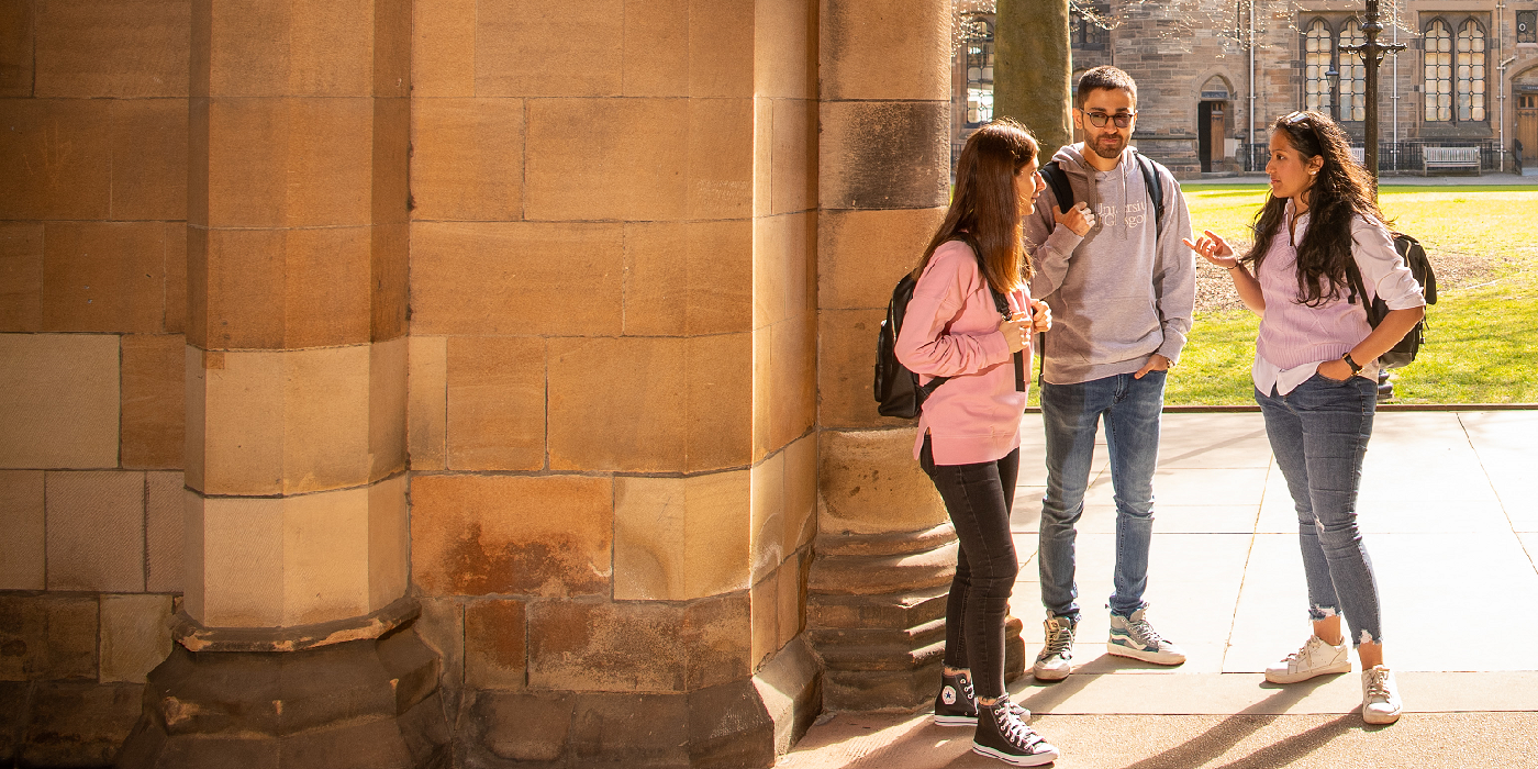 Three students at the cloisters chatting