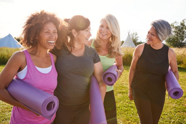A group of four mature women chatting and walking