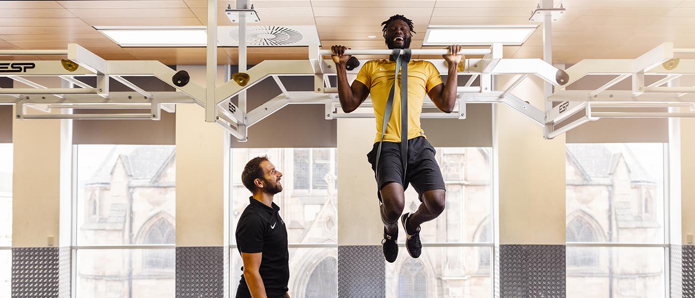 Jeff doing pull-ups in PowerPlay with training coach