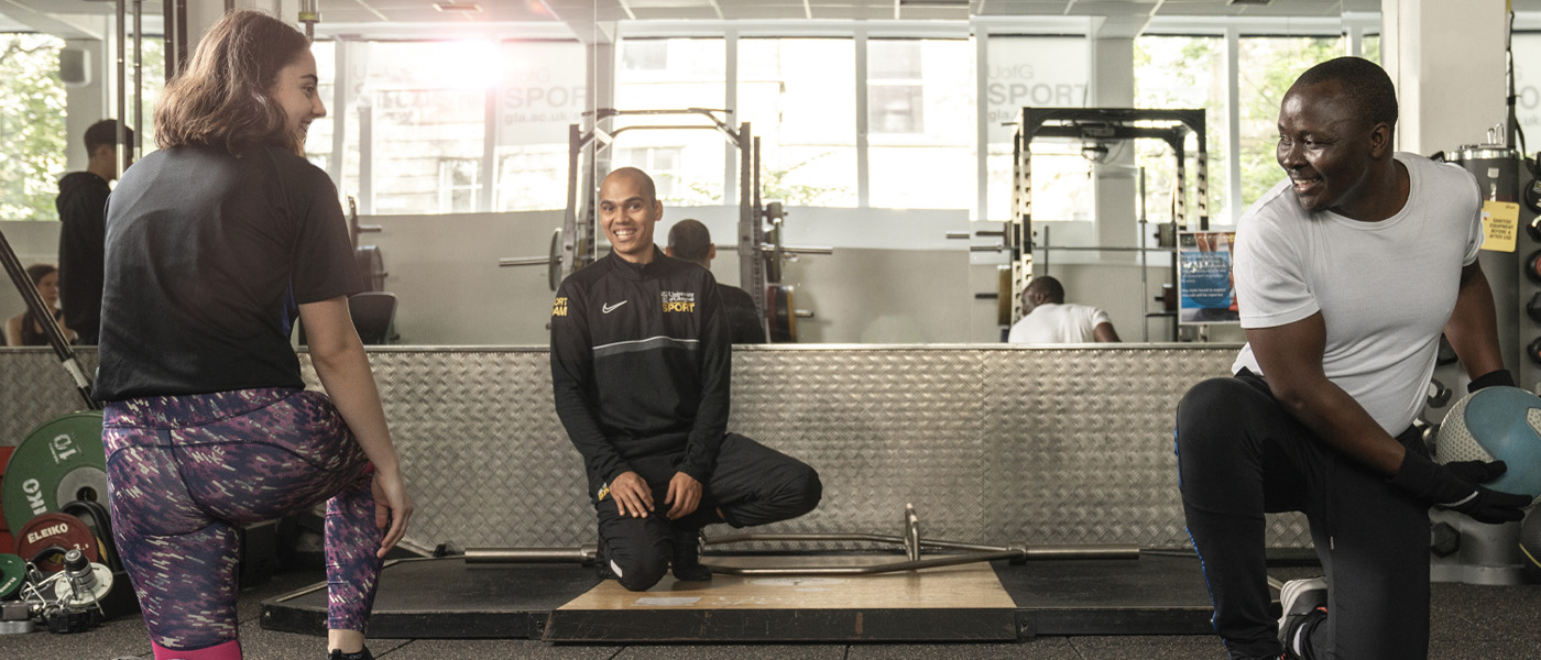 UofG Sport trainer with two members in Studio 3
