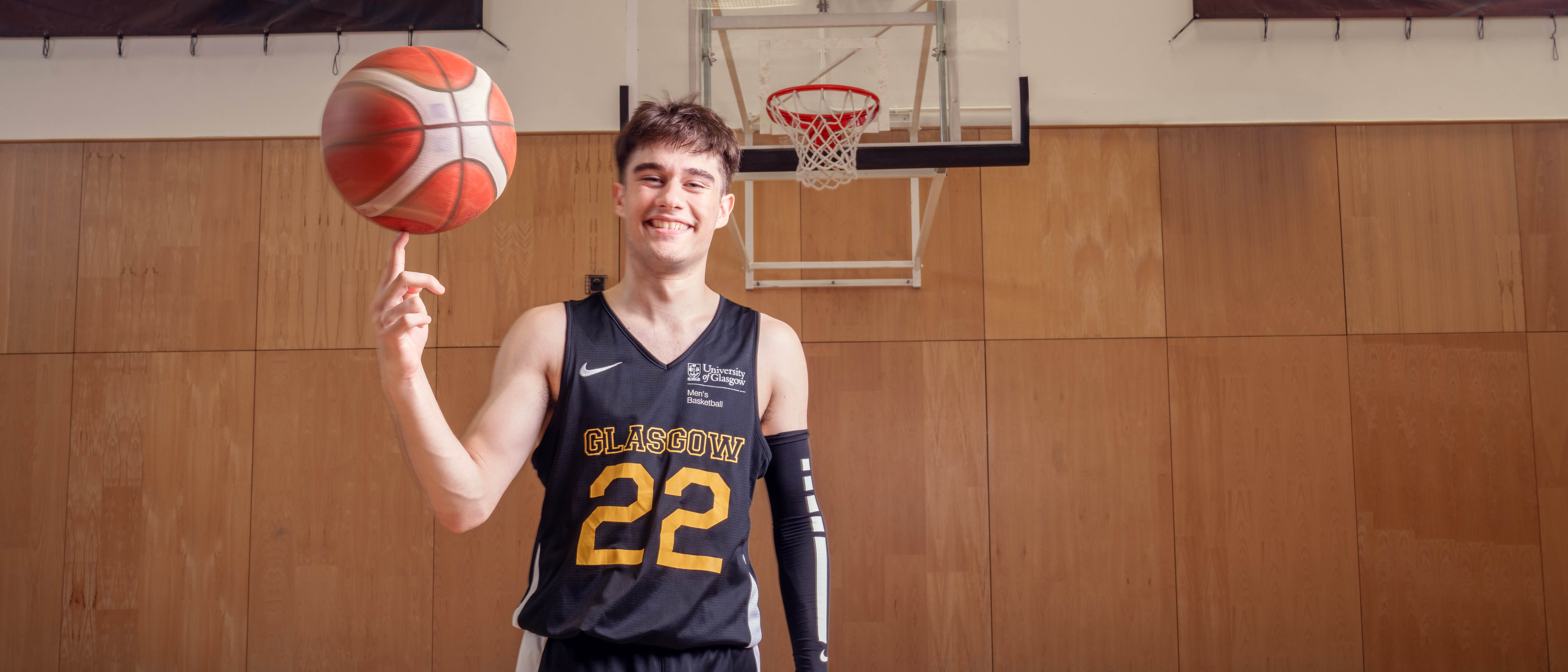 Student basketball player spinning ball on finger