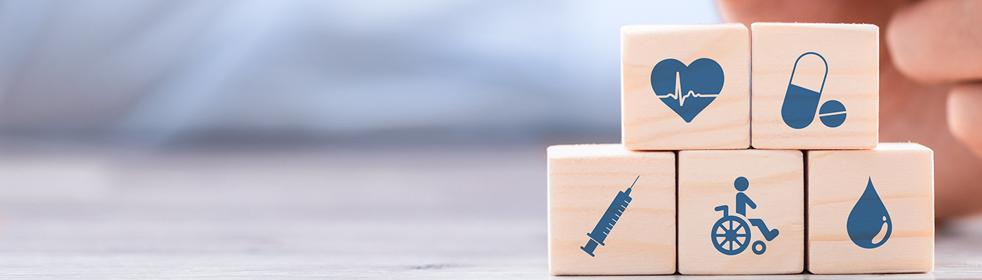 Hand arranging wood block with healthcare medical icon. Health insurance - concept.