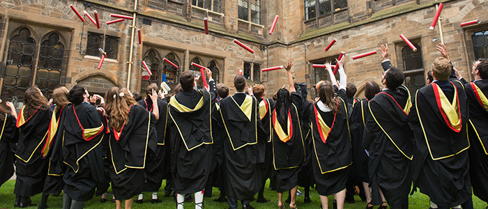 Graduation day - students throwing degrees