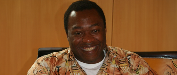 Person sitting at a table wearing a bright shirt