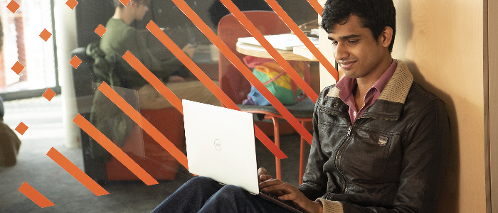 Student sitting with laptop on knees