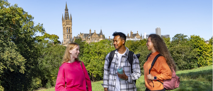 Group of 3 students in Kelvingrove Park with the University tower in the background
