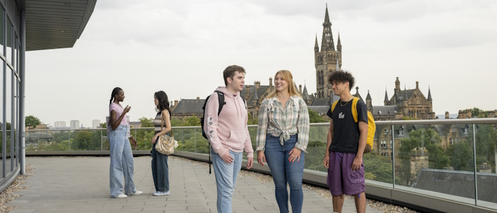 A group of students atop the Wolfson Medical School building viewing the tower 2024