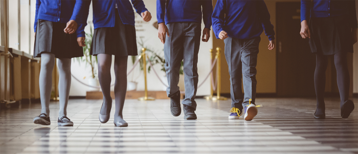 a row of students walking down a hallway