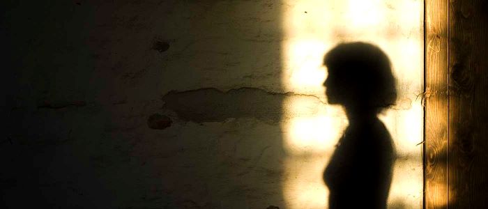 Silhouette of female in front window