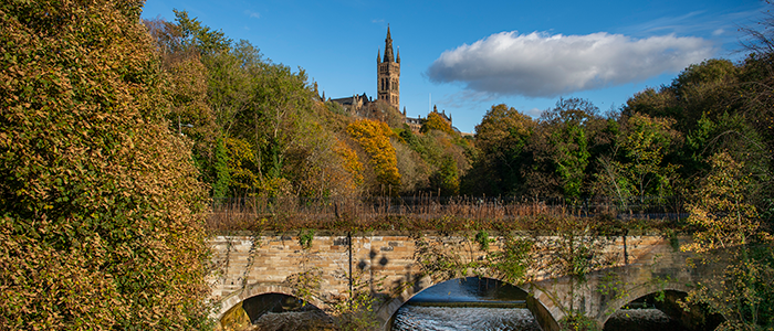 Gilbert Scott Building with bridge in foreground 700x300