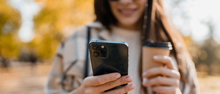 Female student holding mobile phone