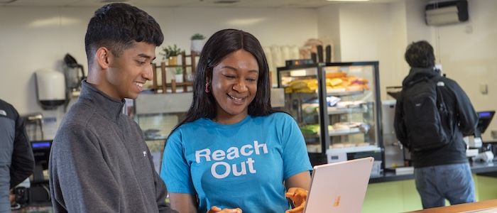 A Reach Out ambassador helping a student