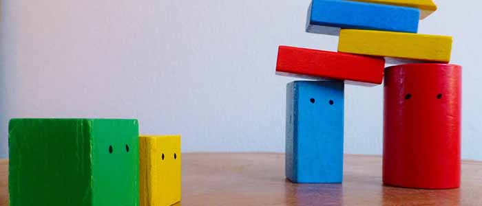 Image of colourful building blocks with cartoon faces