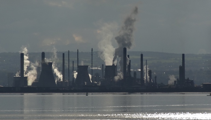 View of Grangemouth oil refinery across the Firth of Forth with smoke and steam coming from lots of different chimneys. Photo credit: Anne Ward, Flickr https://www.flickr.com/photos/ilike/18962645435/