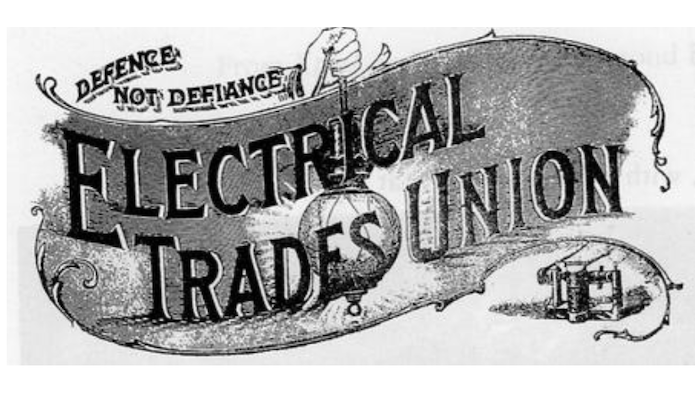 Logo with a banner with the words Electrical Trades Union lit by a lamp with an electric bulb held by a hand and the slogan Defence not defiance