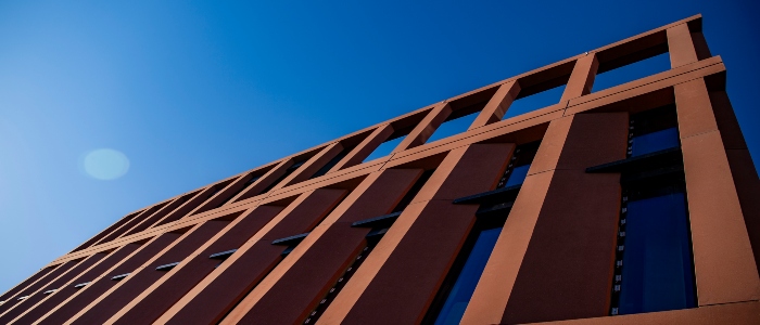 Side of Adam Smith Business School building with blue sky
