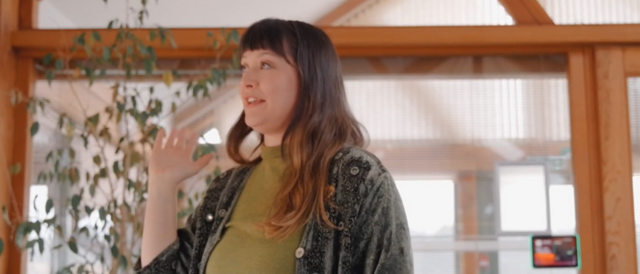 Photo of girl with brown hair, wearing a green blouse