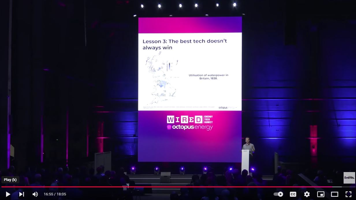 A man presenting a talk in front of an audience