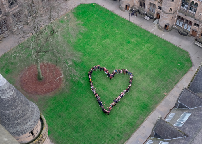 Aerial view of people forming a heart shape on the quadrangle