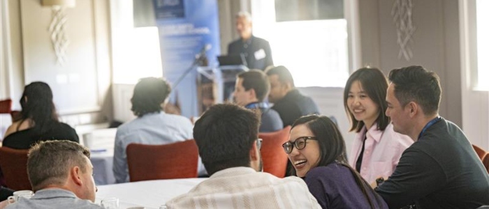 Students smiling at a welcome dinner