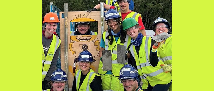 Group shot of student members of the Civil Engineering society, all wearing high vis vests
