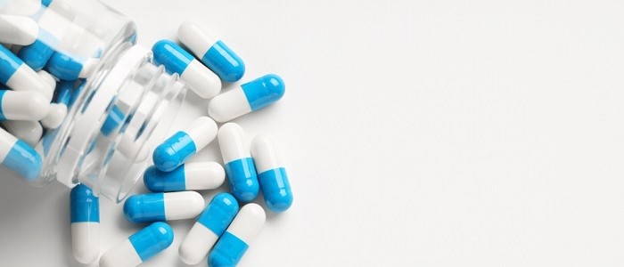 Image of medication spilling out of a bottle