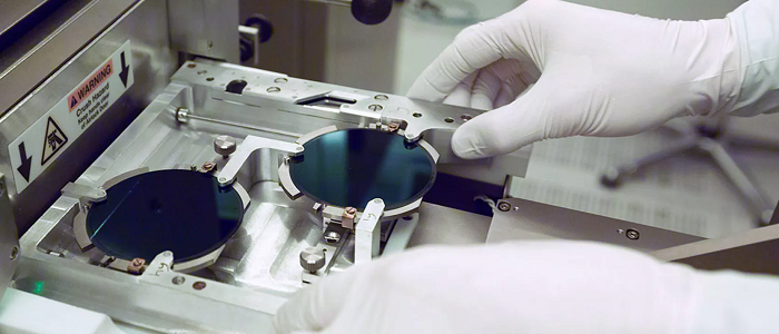 White gloved hands working with nanotechnology