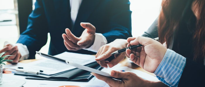 Collaborative office meeting with hands and papers