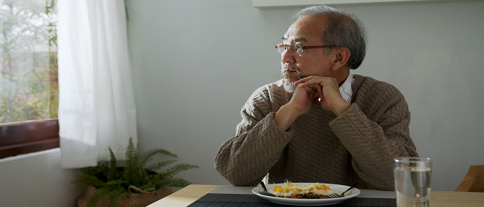 Man sits looking miserable