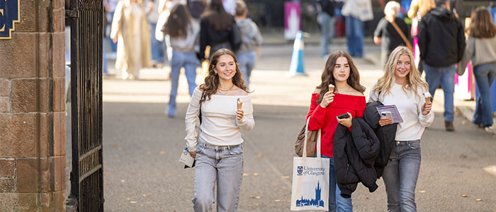 Three girls walking with ice cream cones at Open Day