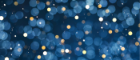 Blue gold and white sparkles on a dark blue background