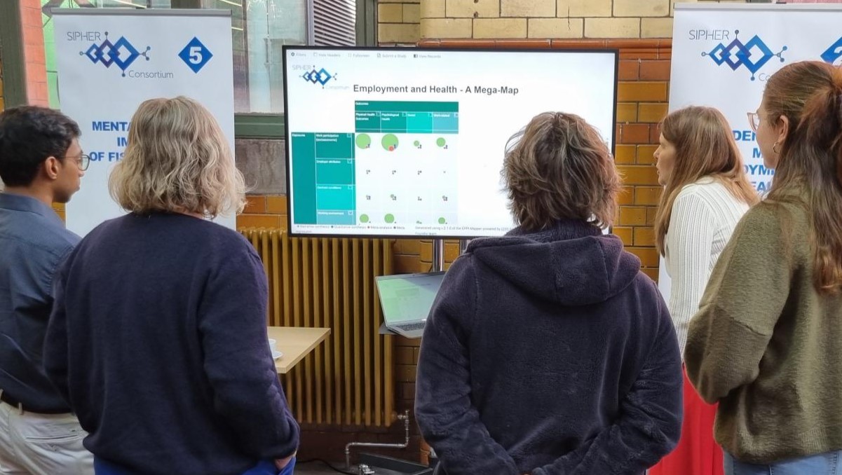 Showcase Delegates standing watching a display demonstration