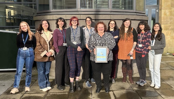 The members of the Sii ECO Group committee stood outside the SGDB with Jen Barrie holding their Gold LEAF Certificate