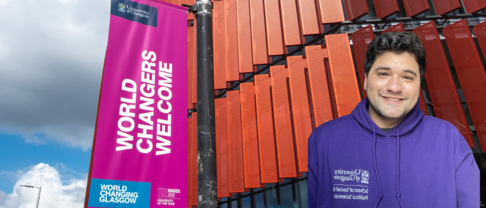 Exterior close up of JMS building with Word Changers Welcome flagpole banner with headshot of smiling man at the front