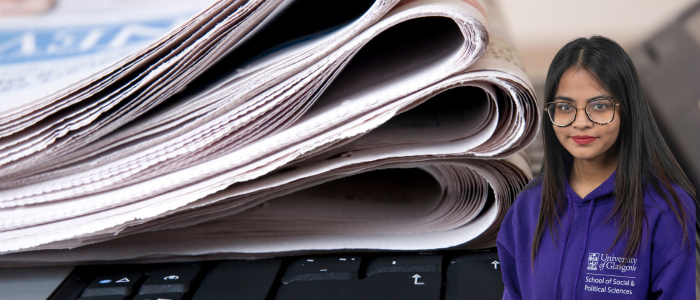 Pile of newspaper sitting on a laptop keyboard with headshot of smiling woman