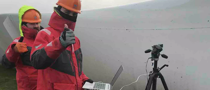 Two students in hard hats using laptop for prognostic testing