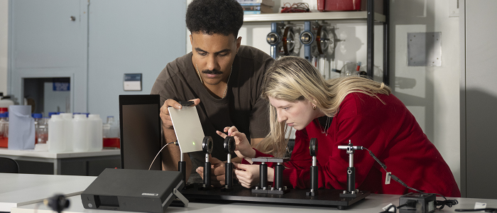 Two physics students conducting research